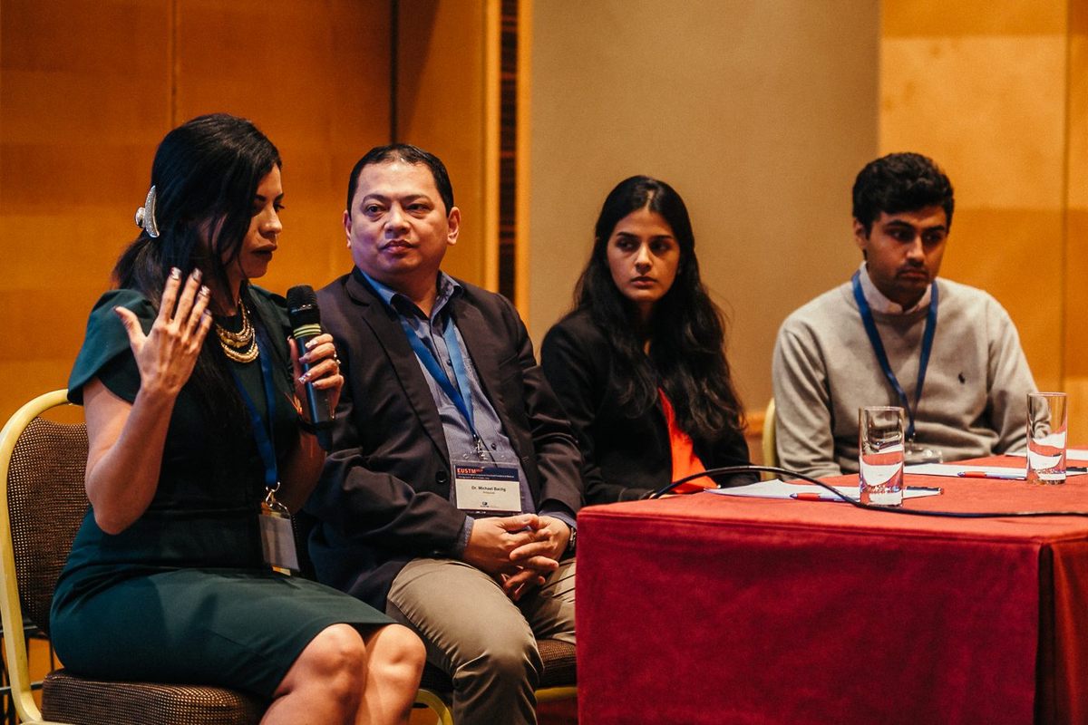 A speaker at the panel table during a session